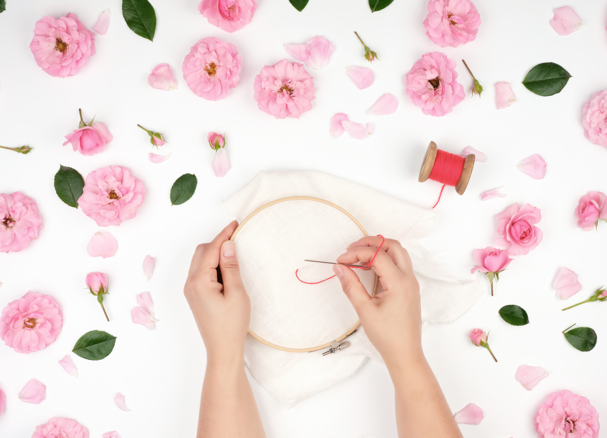 Artisan at work stitching a floral motif